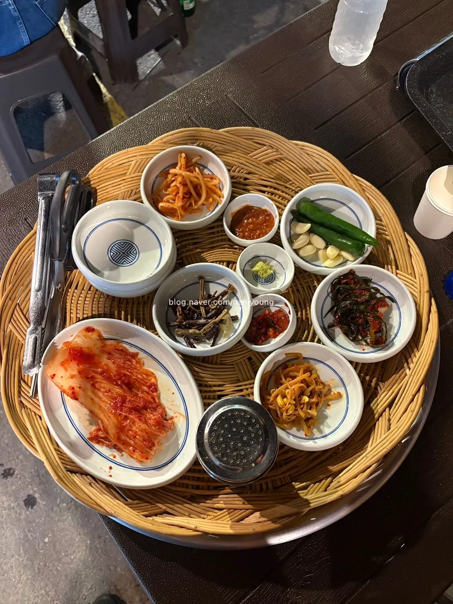 A spread of basic side dishes including green onion kimchi