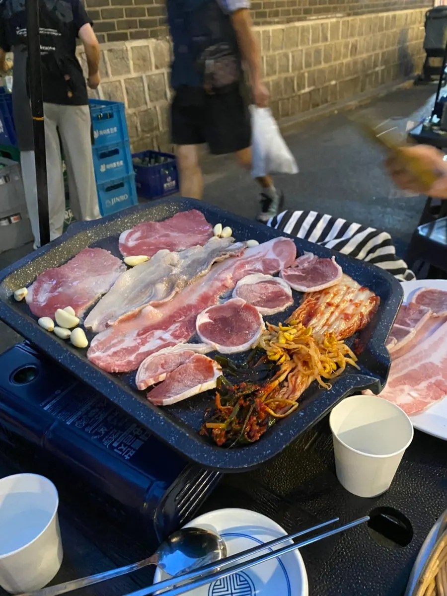 Flash-frozen pork belly and pork collar on the grill