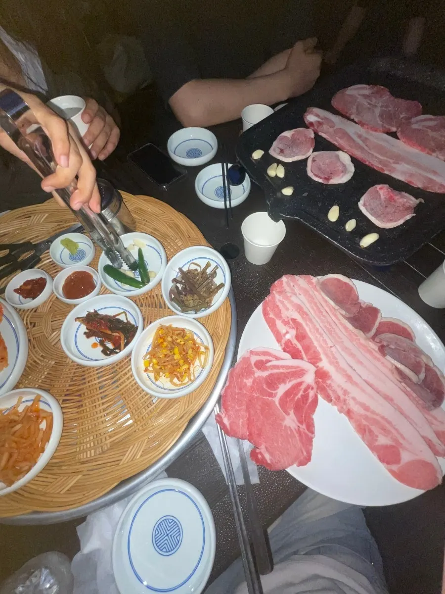 Garlic and kimchi grilling at the edge of the pan