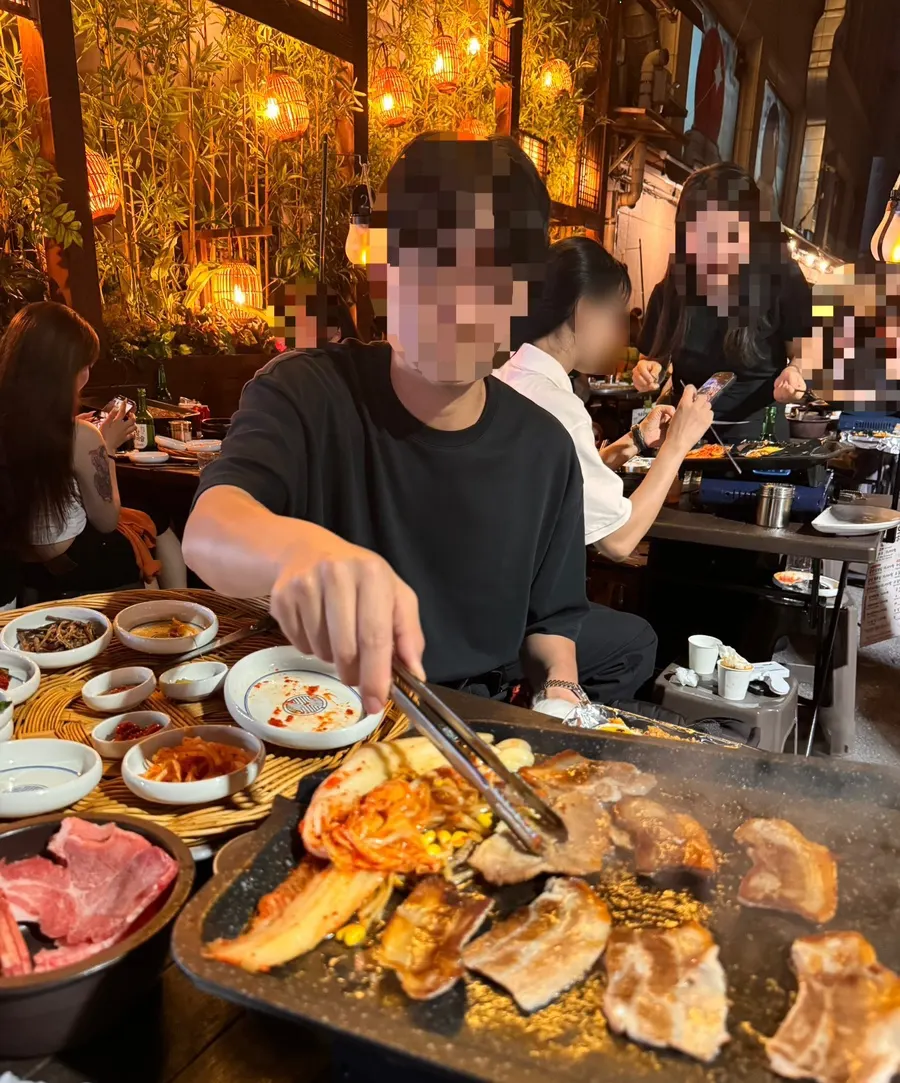 Meat meal enjoyed in a lively outdoor tent setting
