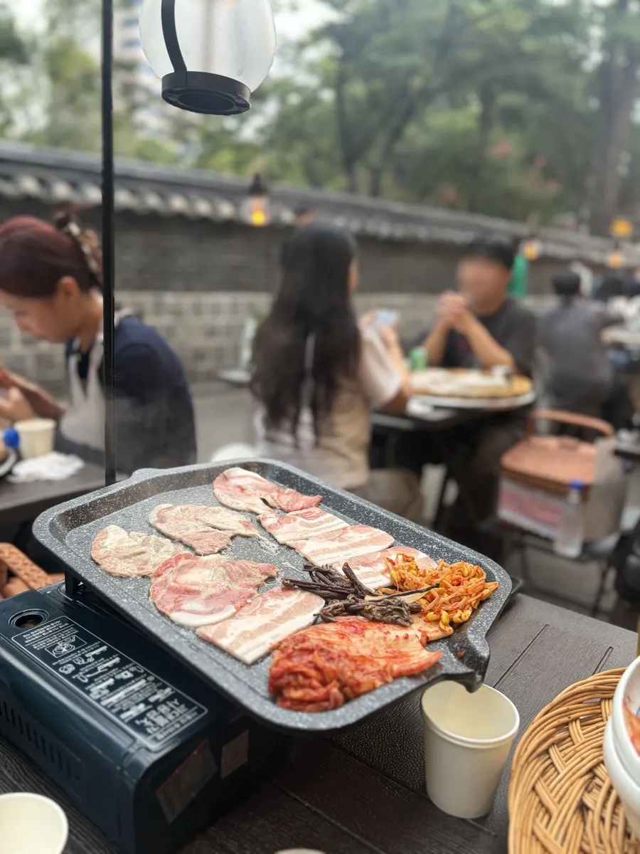 Pork belly, kimchi and bean sprouts on the grill