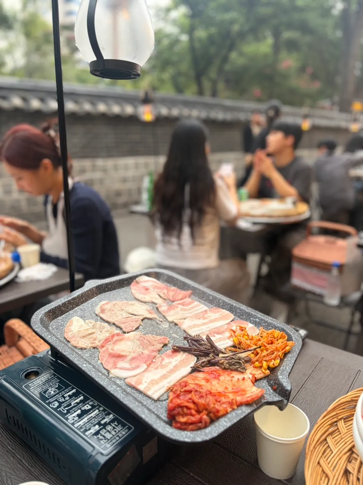 Pork belly and pork neck grilling at the Jongno 3-ga outdoor BBQ spot