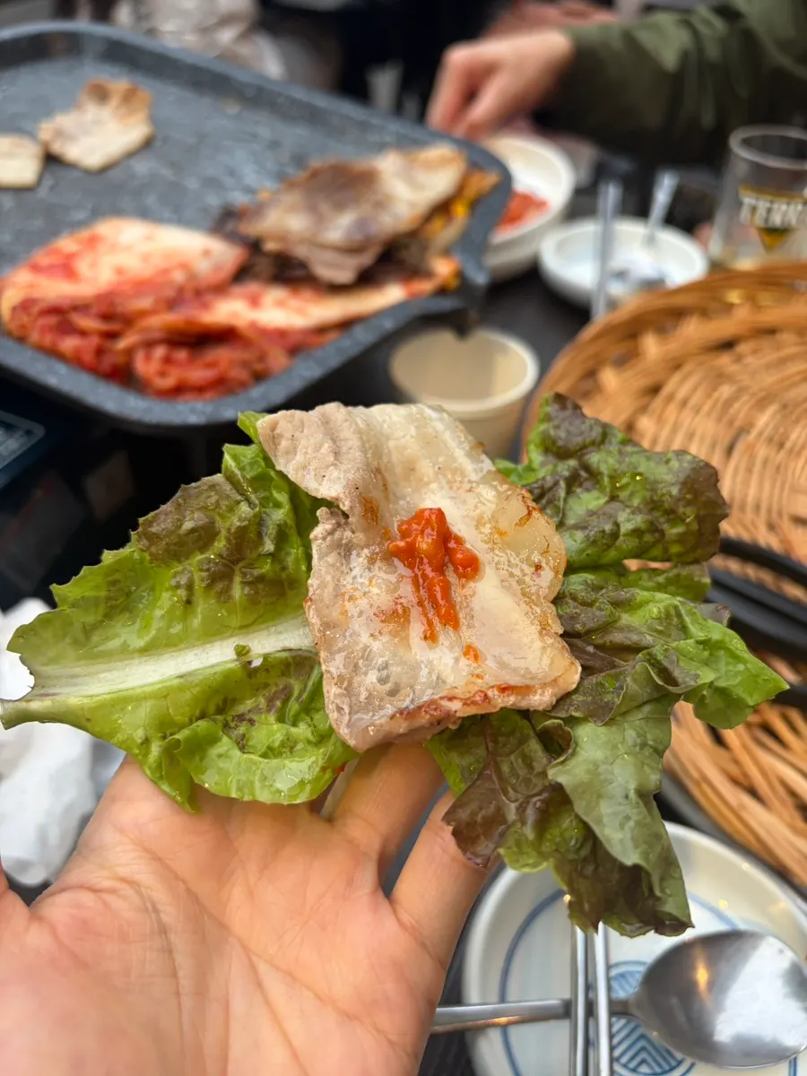 A lettuce wrap with ssamjang and grilled meat