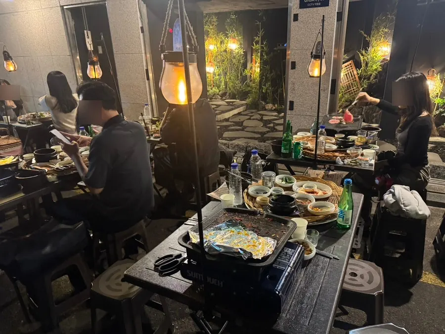 Rows of outdoor grill tables spread widely outside