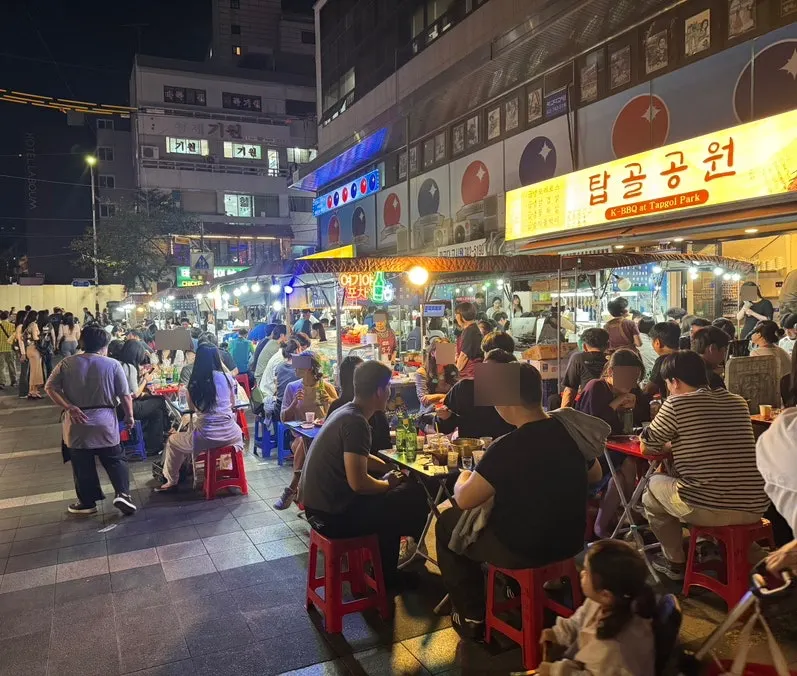 Tables packed close together on a typical Jongno 3-ga outdoor grill strip