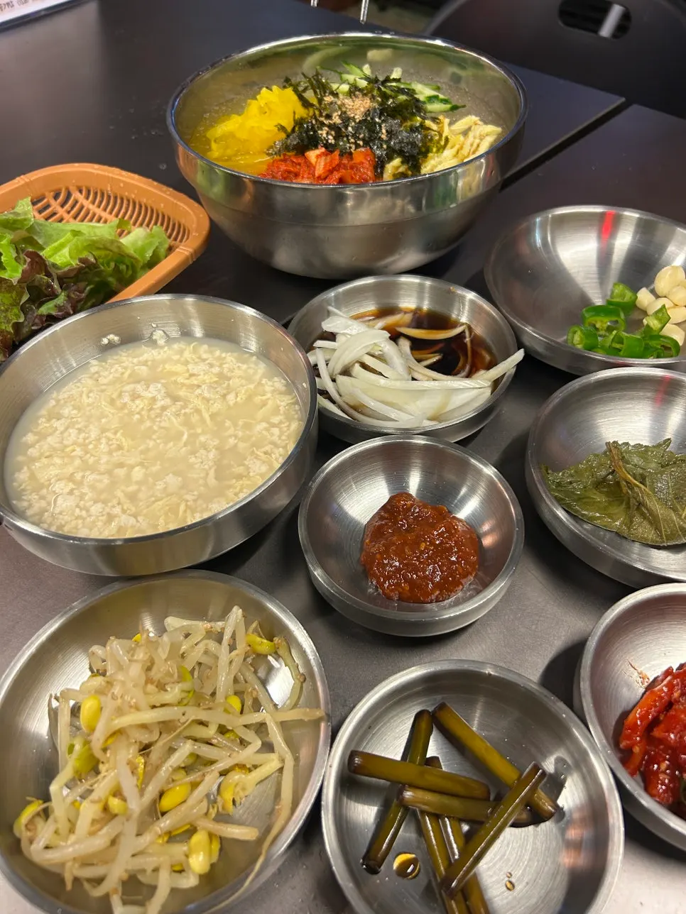 Basic side dishes and kimchi noodle soup set on the table