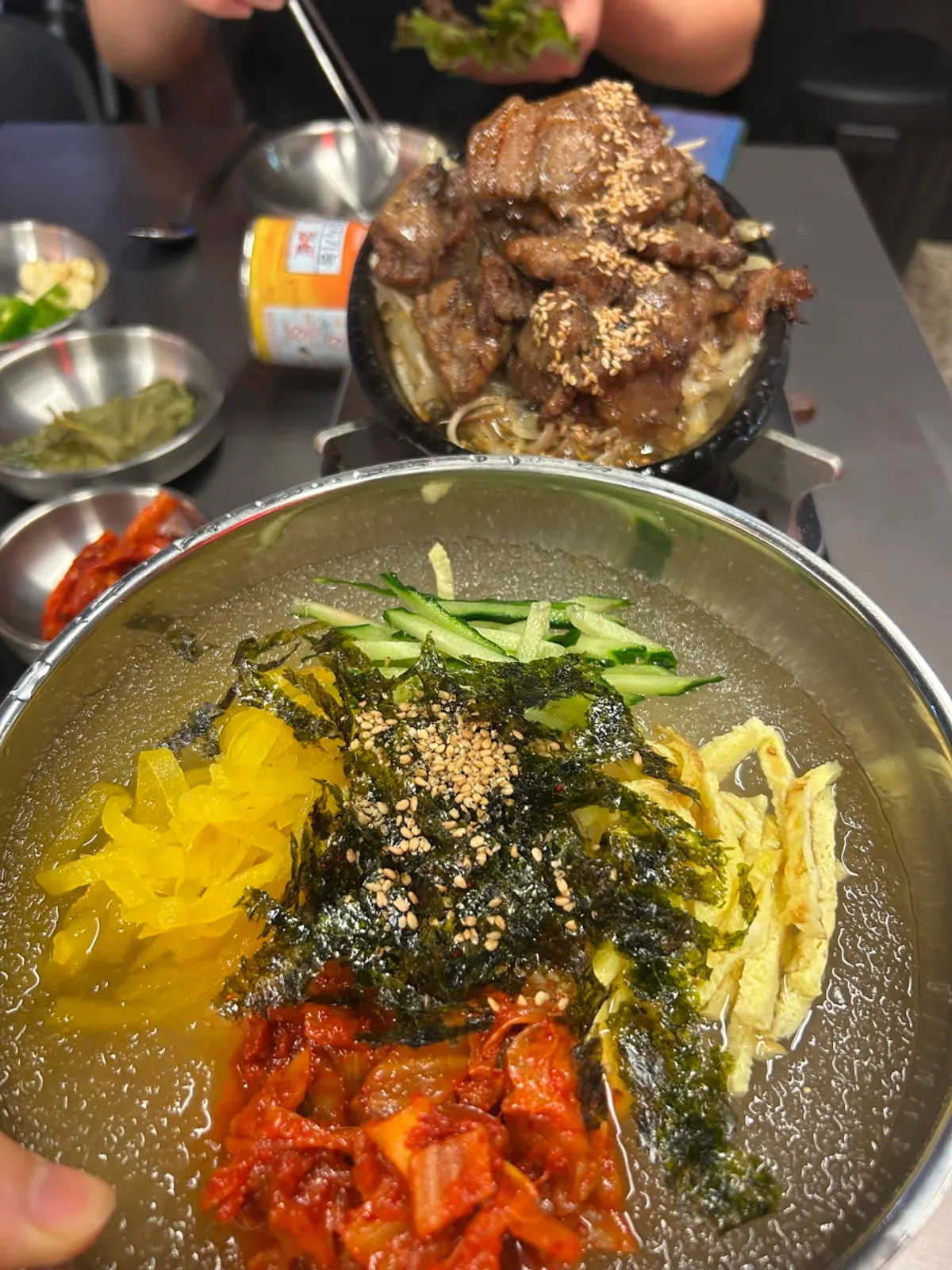 Juyukjeom's black pork and kimchi noodle soup spread