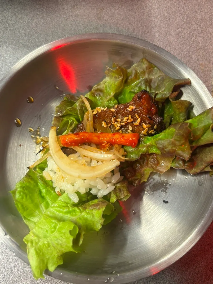 A piece of red pork belly on lettuce