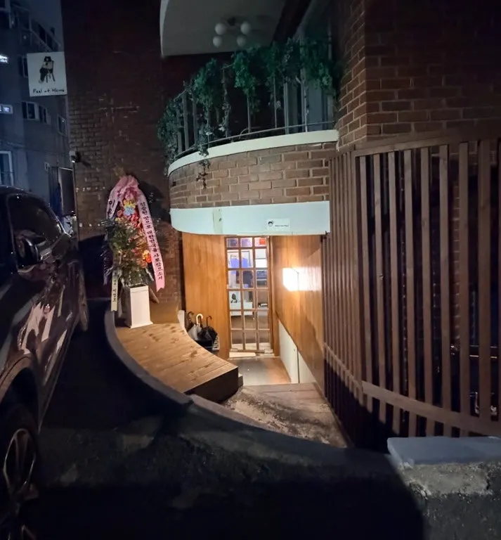 Joseonmakhae's entrance lit up in a dark alley