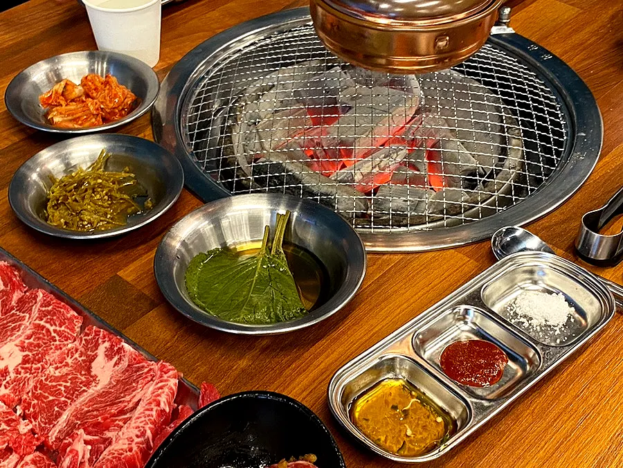 Side dishes including pickled peppers and pickled perilla leaves