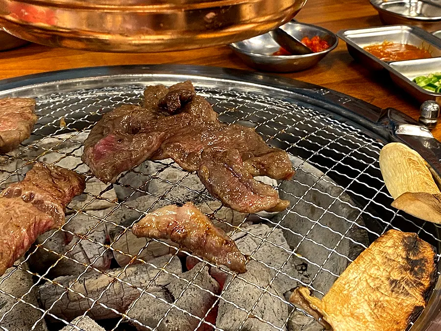 The grill continuing to cook the remaining cuts
