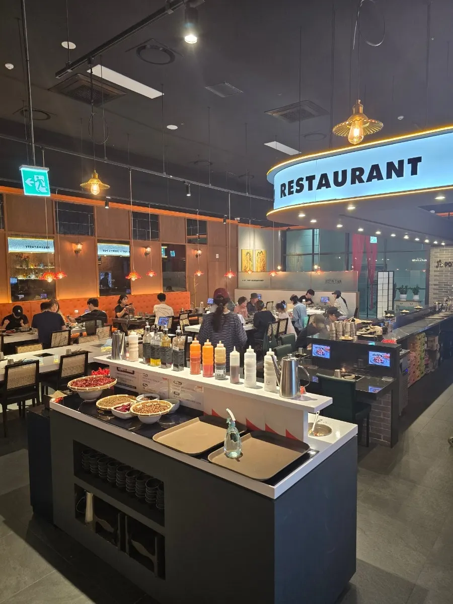 Hot pot restaurant seating with pendant lights and cane chairs