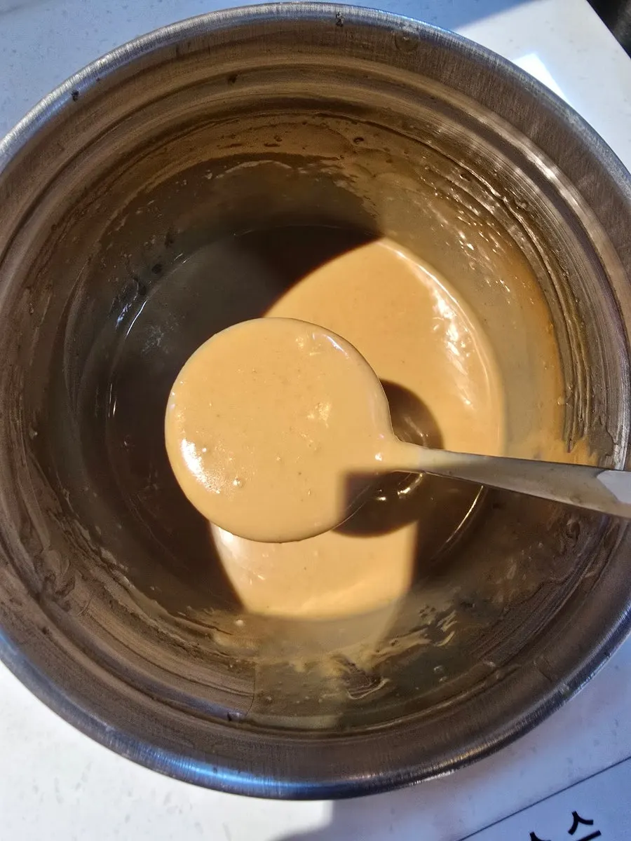 Self-serve sauce bar at the center of the restaurant with sauce ingredients