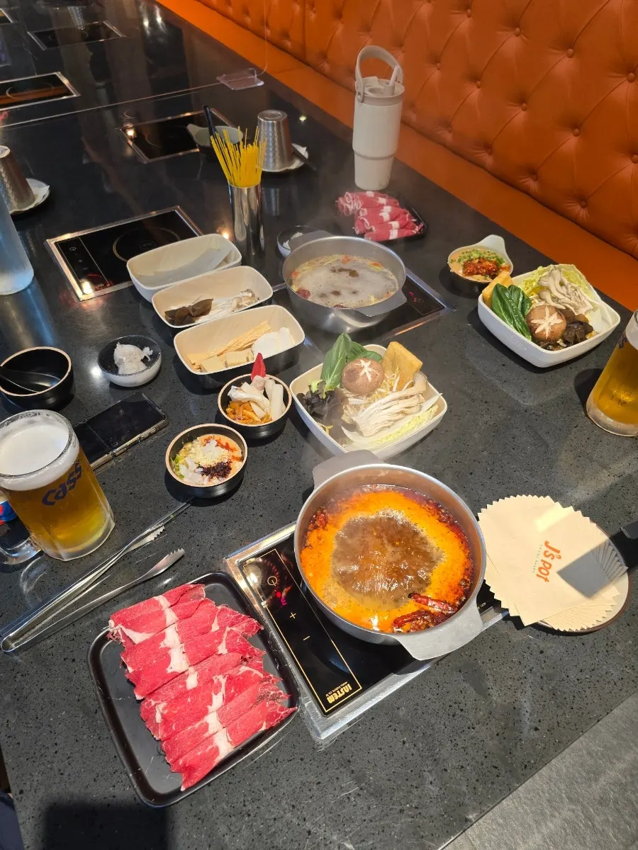 Table filled with hot pot ingredients and table setting