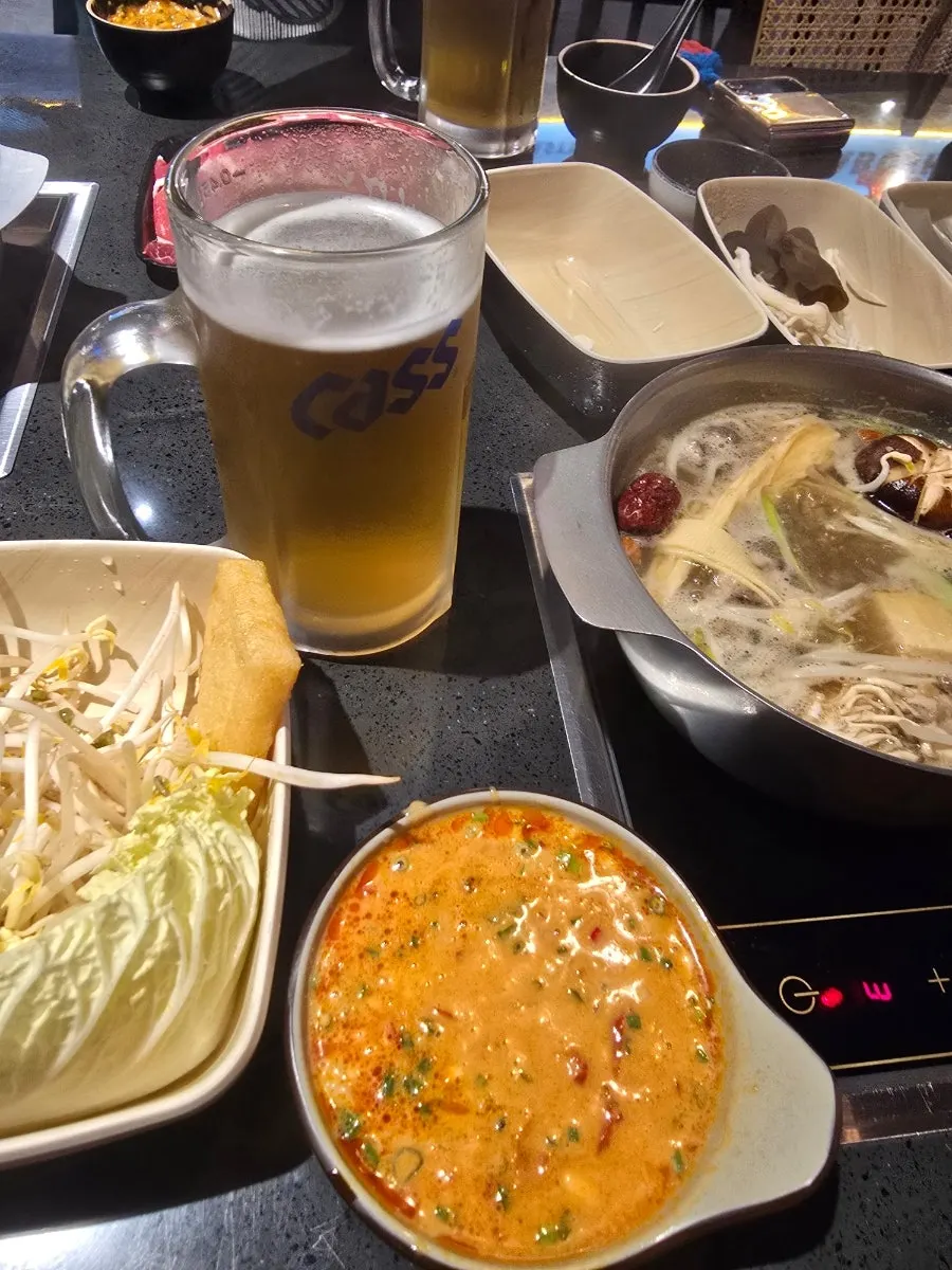 Cold glass of draft beer enjoyed alongside the hot pot
