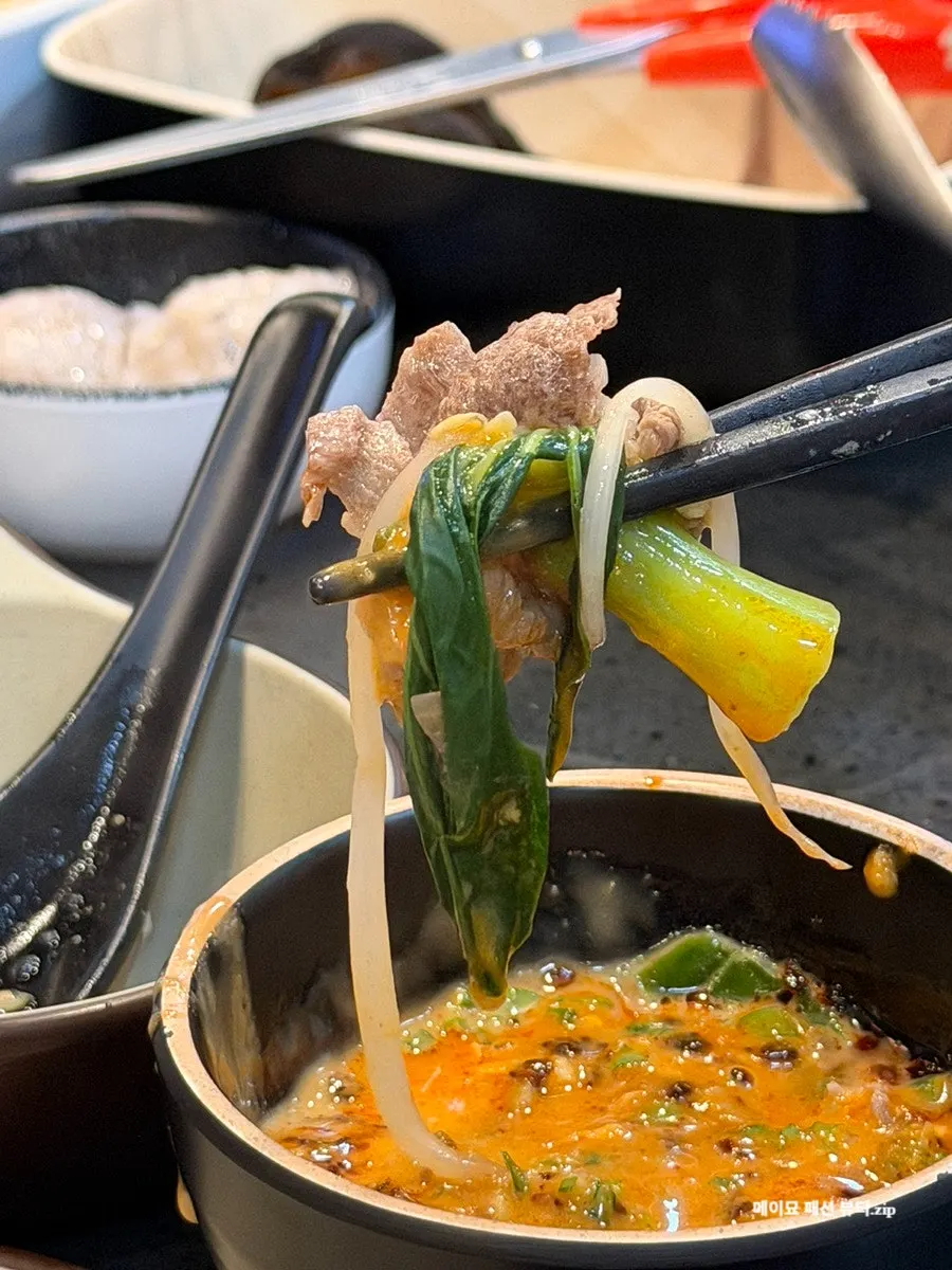 Plate of dumplings and bok choy scooped out of the pot