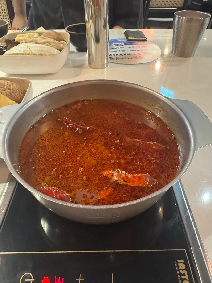 Tomato broth in an individual hot pot