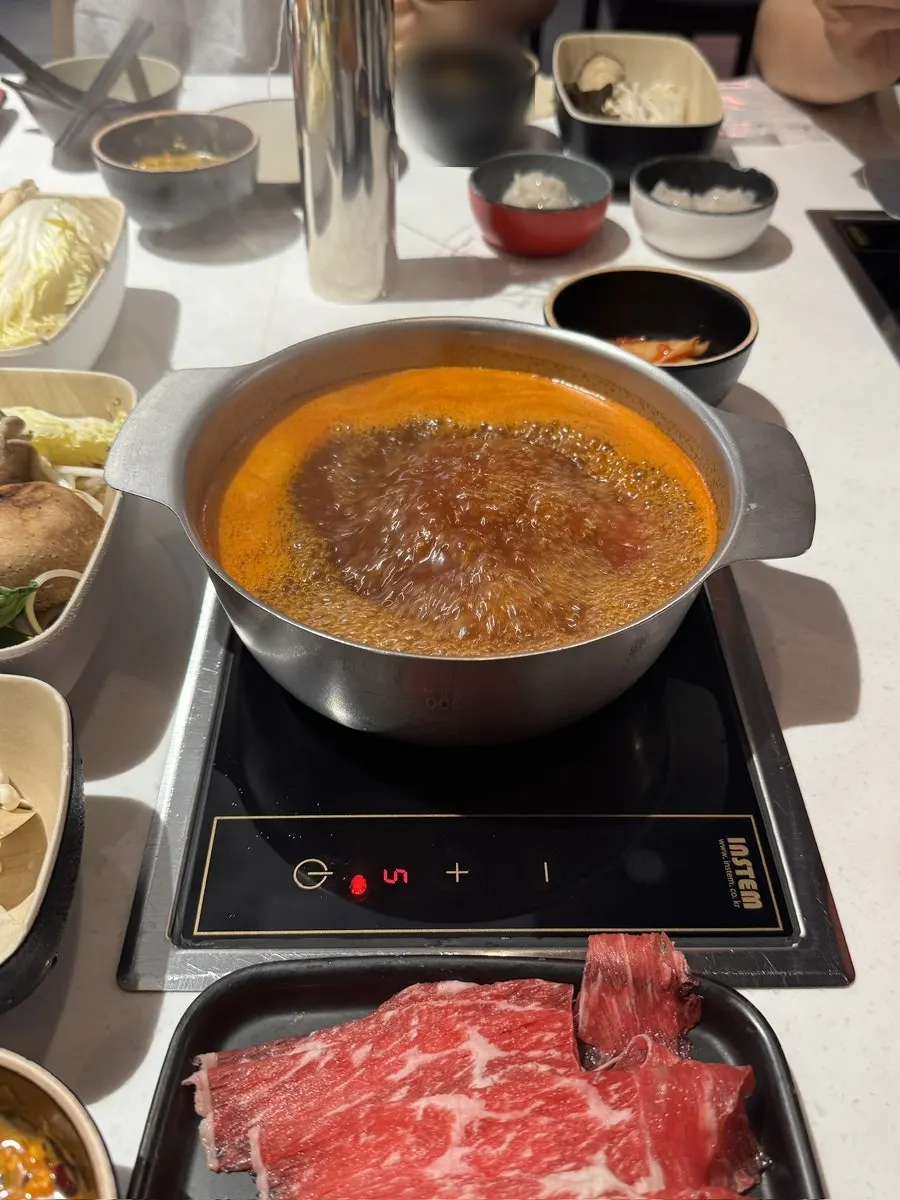 Individual hot pot broth starting to boil