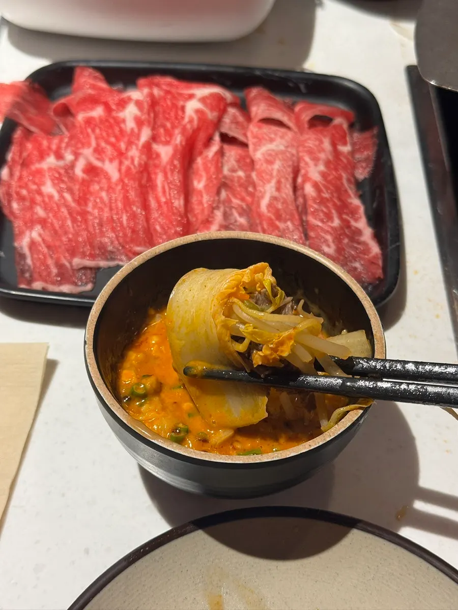 First bite of the tomato broth hot pot