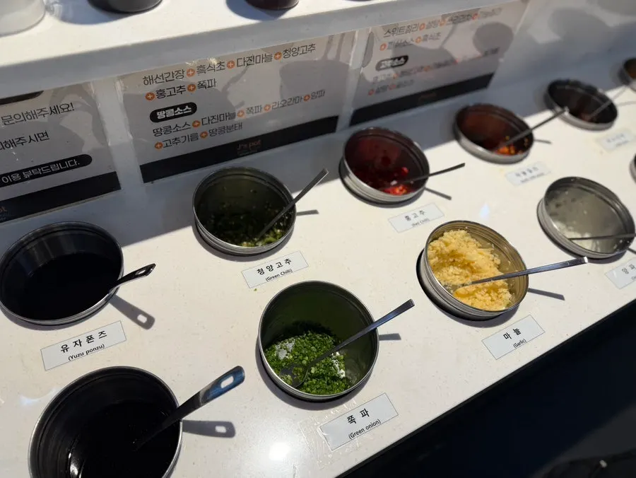 Table with both mala broth and beef broth pots side by side