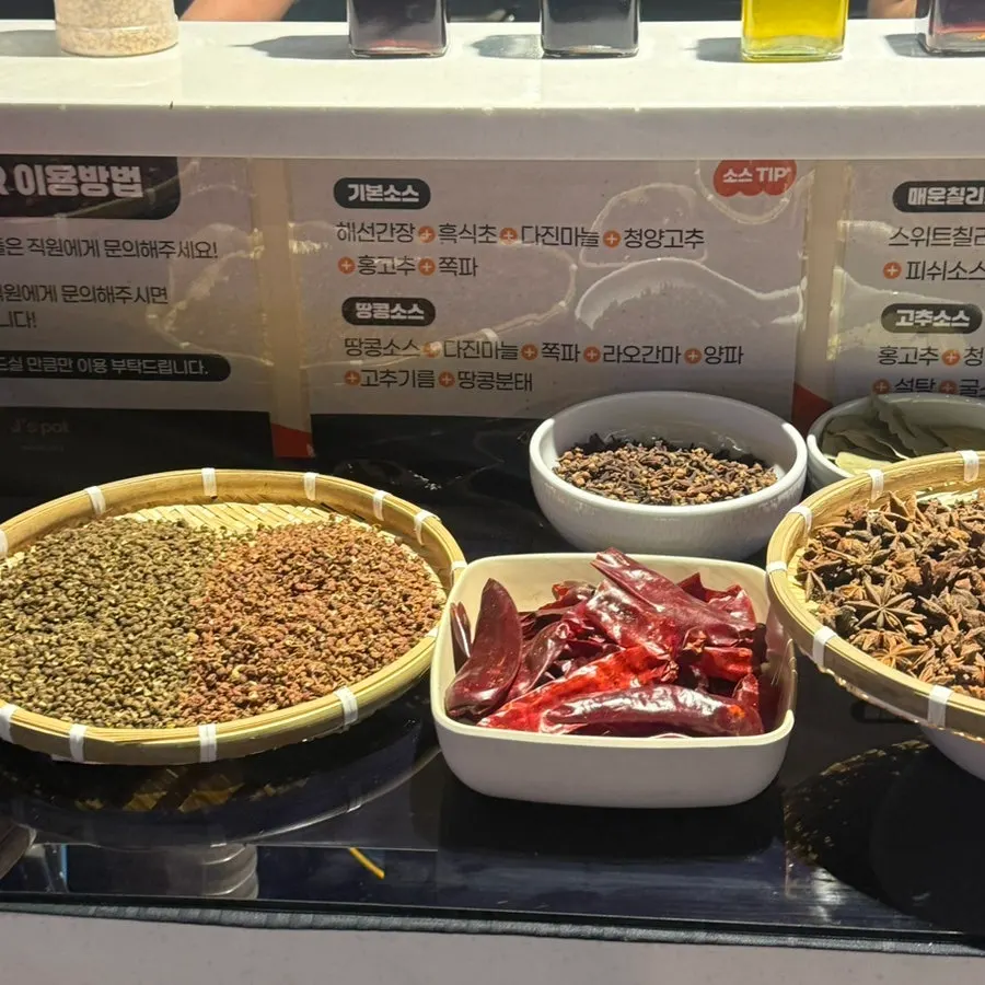 Several sauces set out at the hot pot sauce corner