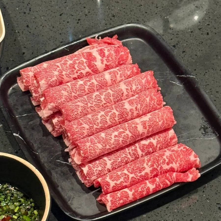 Hot pot and side dishes set out on the table