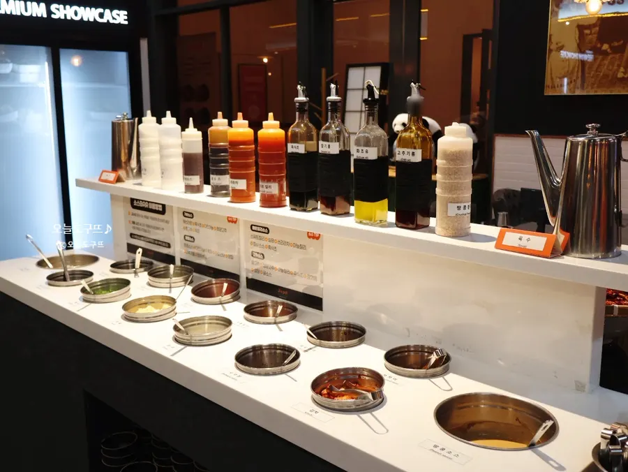 Sauce bar with sesame oil, chili oil, and various toppings