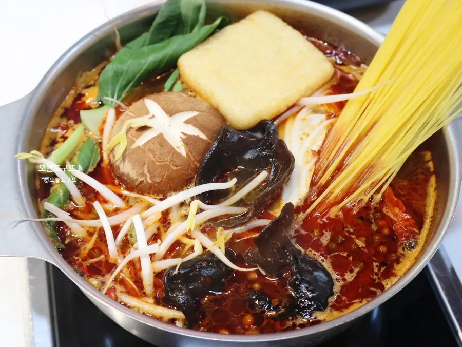 Hot pot simmered with bean sprouts, bok choy, mushrooms, and fried tofu