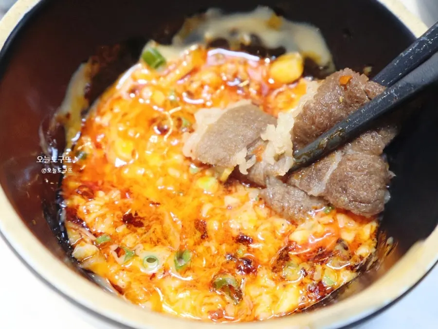 Meat cooked in the broth dipped in peanut sauce