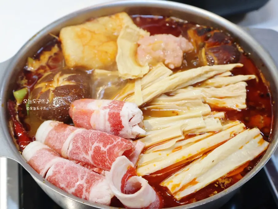 A personal hot pot boiling away, packed full of ingredients