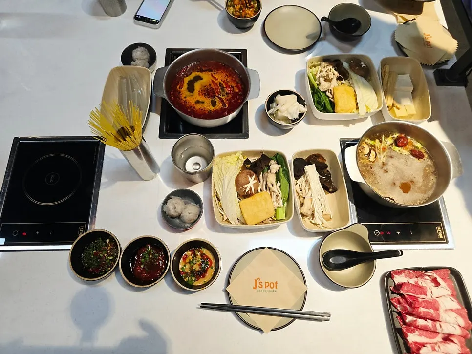 Table laid out with beef set and mala set ingredients