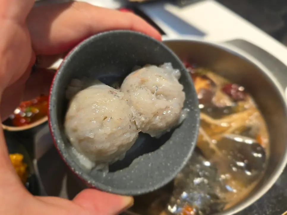 Hot pot with shrimp balls added