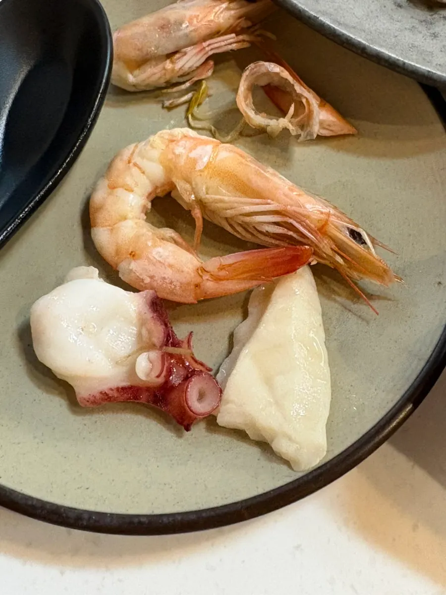 Seafood hot pot simmering with seafood added