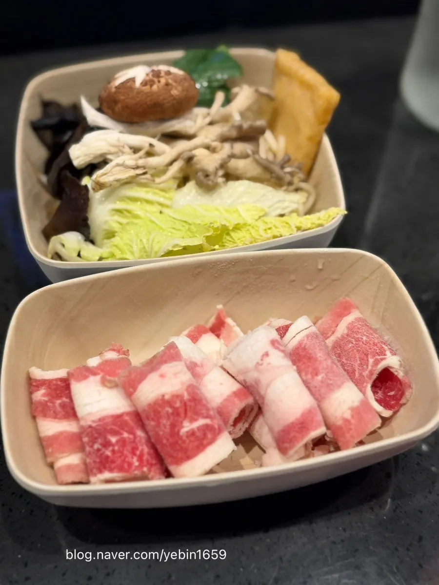 Pot of simmering shabu-shabu with vegetables and mushrooms