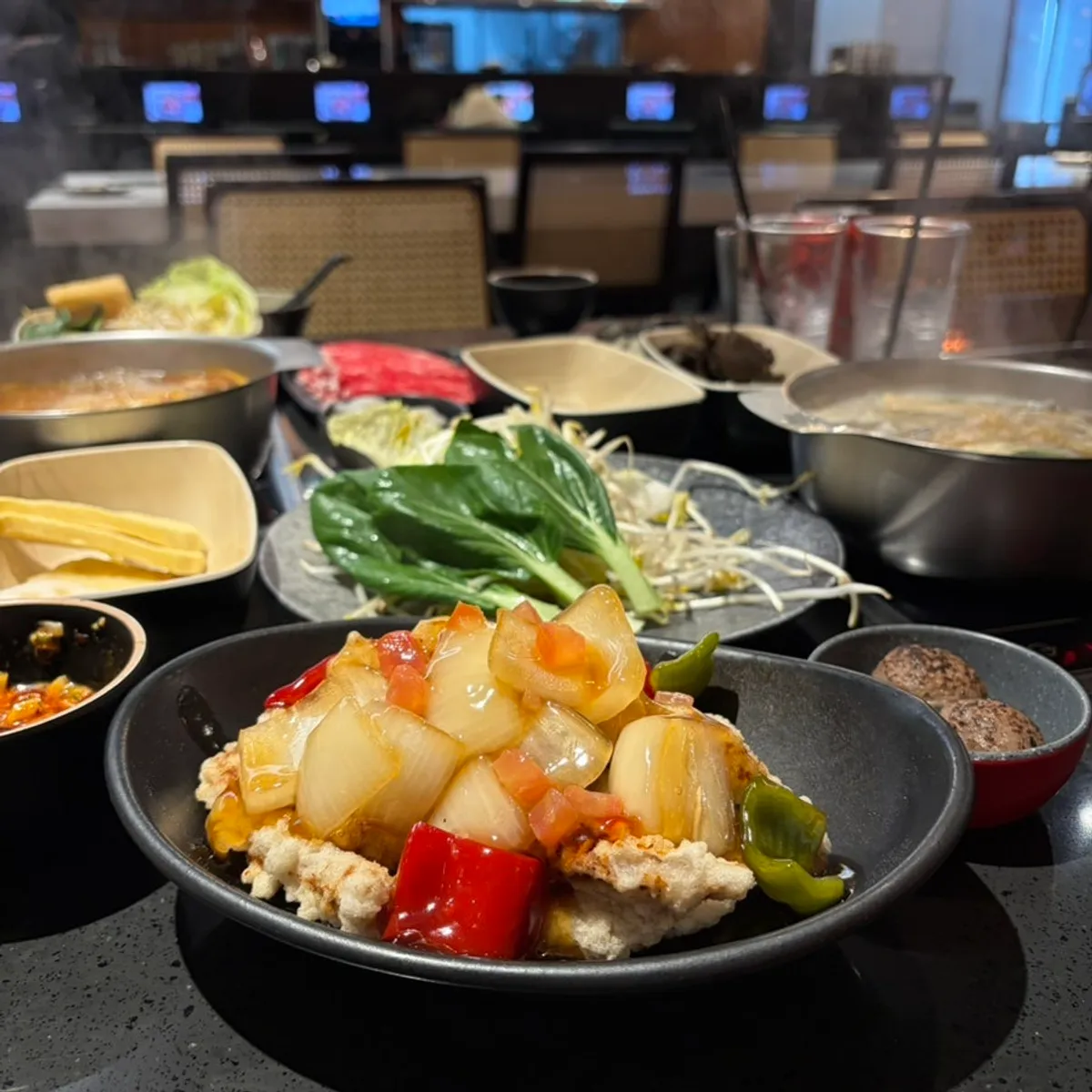 Table set with tom yum hot pot and pork bone hot pot