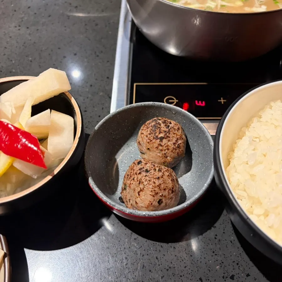 Grilled meatballs served with the pork bone hot pot