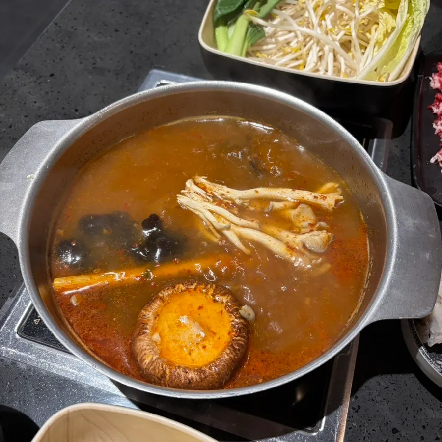 Tom yum hot pot simmering with the mushroom assortment
