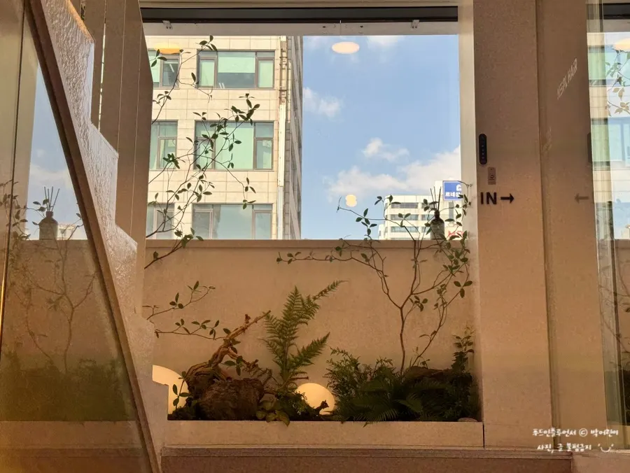 화이트와 초록색이 어우러진 미용실 외관