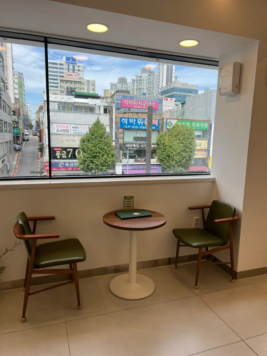 Salon seats lit by floor-to-ceiling windows