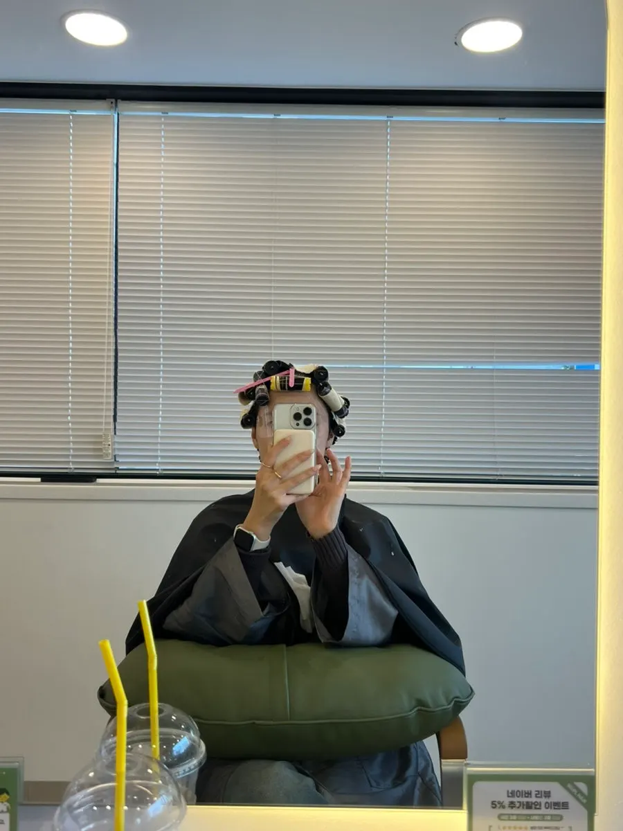 Hippie perm in progress with rods being wrapped