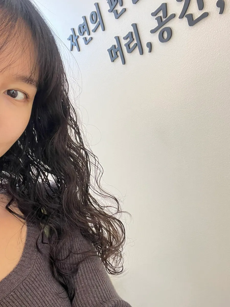 Hippie perm curls starting from above the temples
