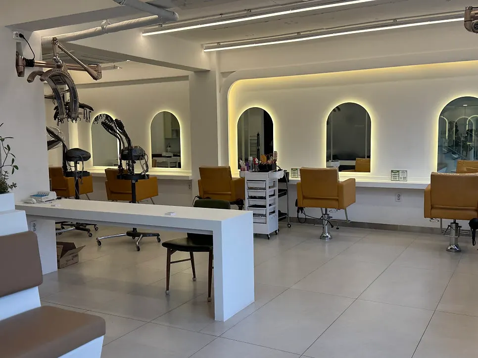 Row of mirrors and styling chairs inside the salon