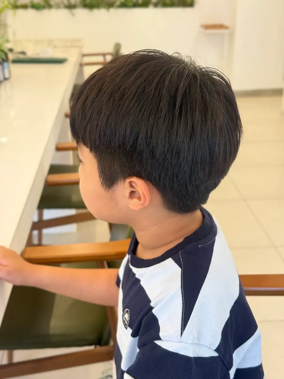 The child's before hair, prior to the perm