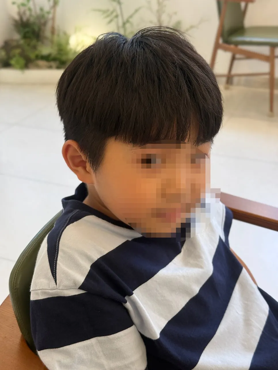 Child's hair before treatment, with sides sticking out