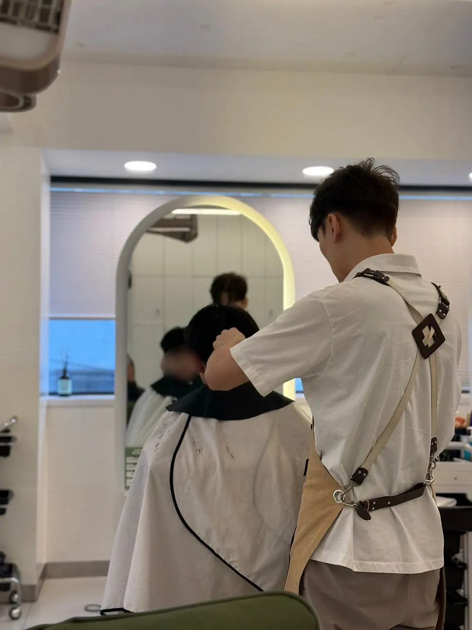 The designer cutting the child's hair