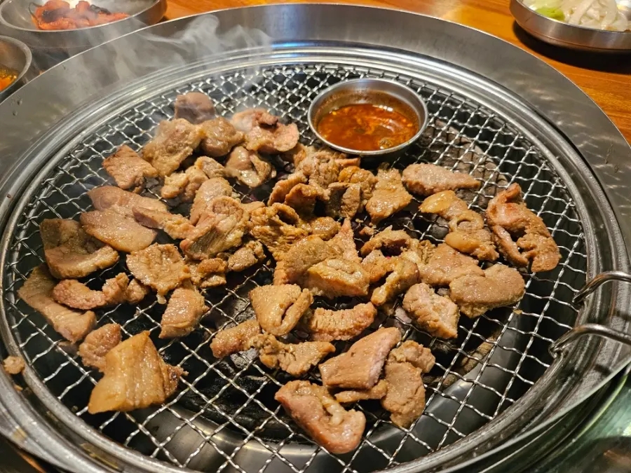 Pork ribs grilled by a staff member