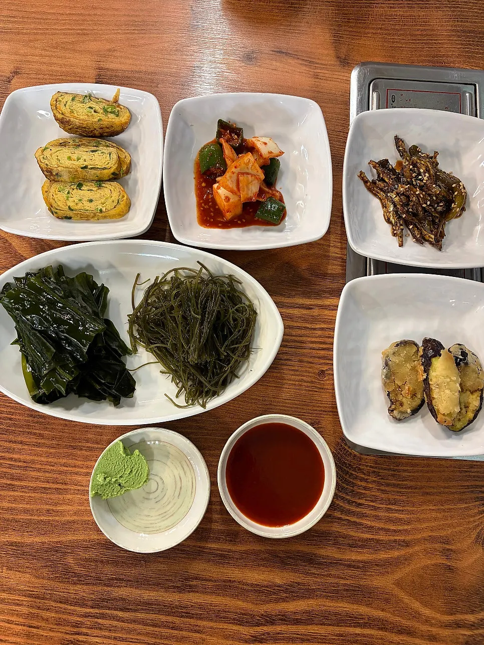 Table setting with basic side dishes and seaweed stems