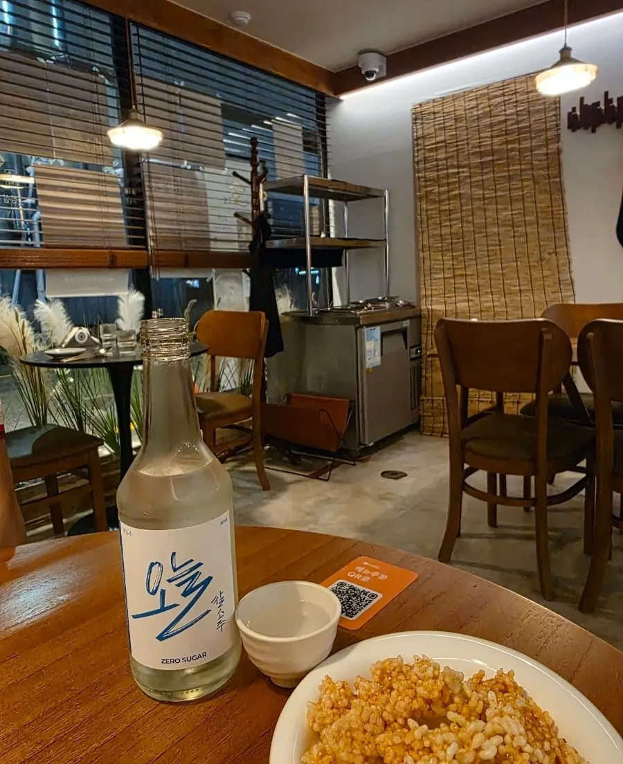 Bottle and glass of traditional liquor at Jumak Inho