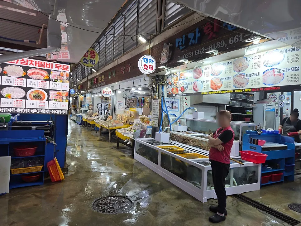 Row of sashimi centers along a passage in Jumunjin Fish Market