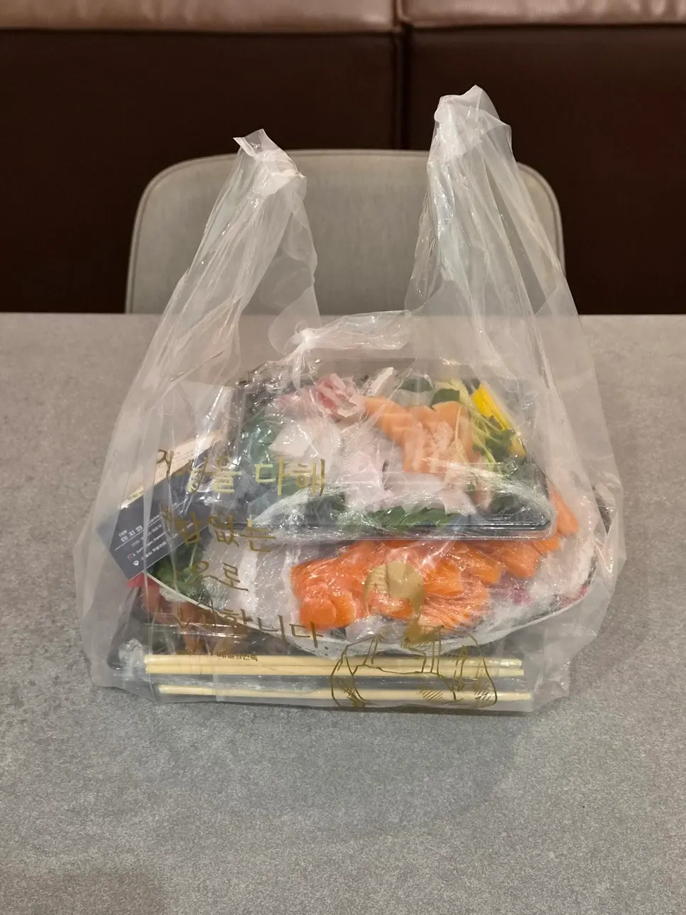 Completed takeout bag of sashimi from Haesong Hoetjip